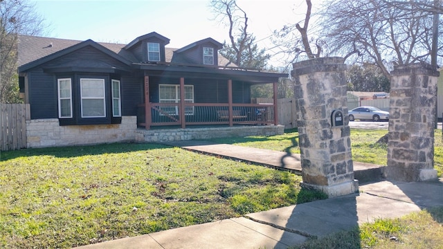 view of front facade featuring a front lawn and covered porch