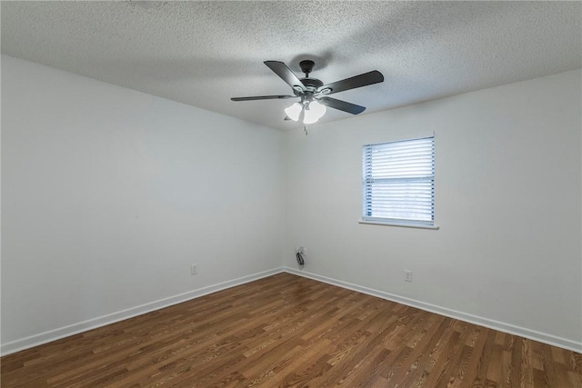 spare room with a textured ceiling, ceiling fan, and dark wood-type flooring