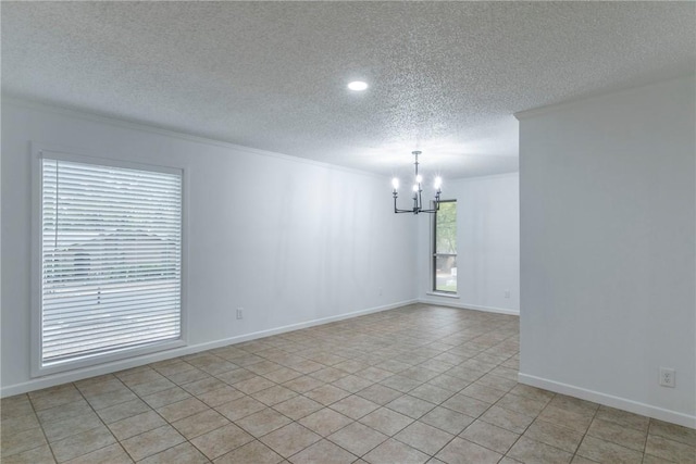 spare room with light tile patterned flooring, a textured ceiling, and a notable chandelier