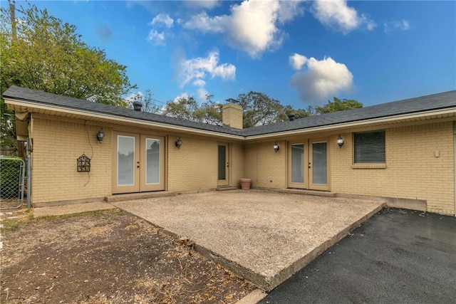 rear view of property featuring french doors and a patio