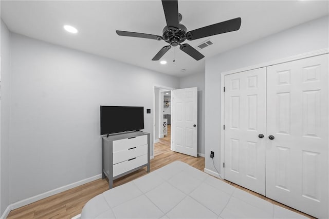 bedroom with recessed lighting, a closet, visible vents, wood finished floors, and baseboards