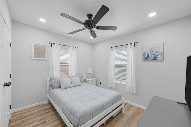 bedroom with recessed lighting, baseboards, and light wood finished floors