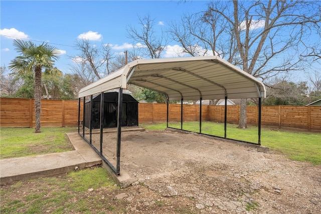 view of parking with a fenced backyard and a detached carport