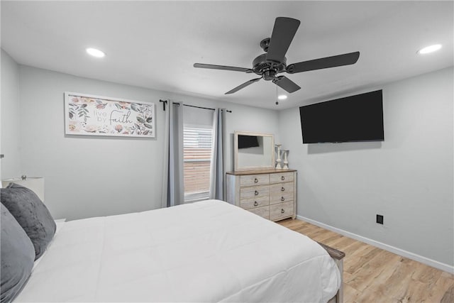 bedroom with baseboards, wood finished floors, and recessed lighting