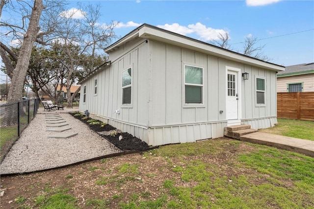 exterior space with entry steps and a fenced backyard