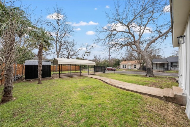 view of yard with an outbuilding, a storage unit, and fence