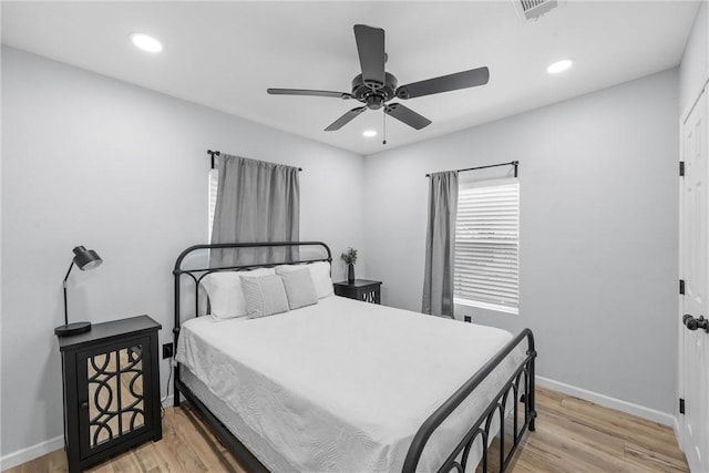 bedroom featuring light wood-type flooring, baseboards, visible vents, and recessed lighting