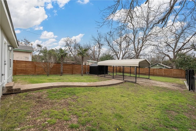 view of yard featuring a detached carport and a fenced backyard