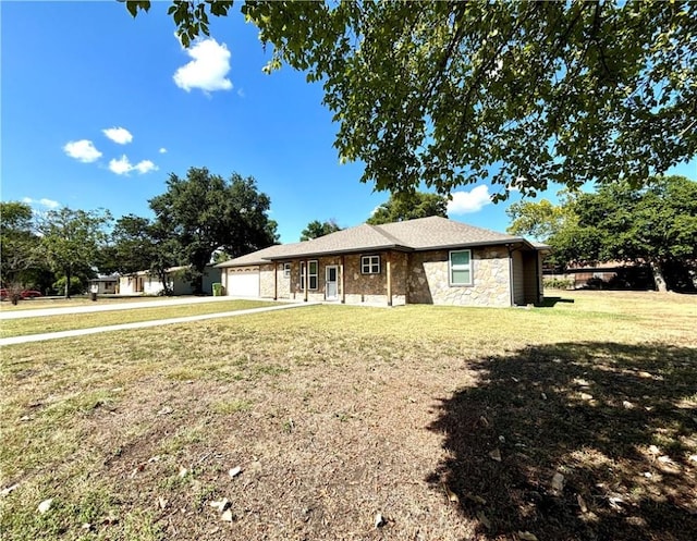 single story home featuring a garage and a front lawn