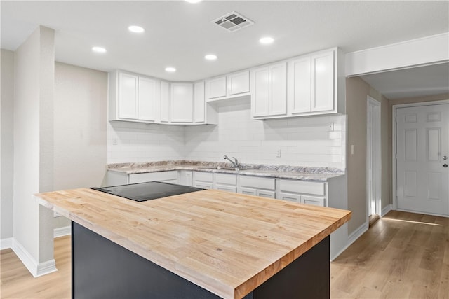 kitchen featuring backsplash and white cabinetry