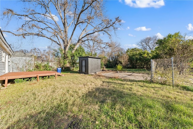 view of yard featuring a shed and a deck