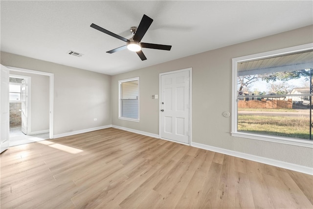 interior space with light hardwood / wood-style floors and a wealth of natural light