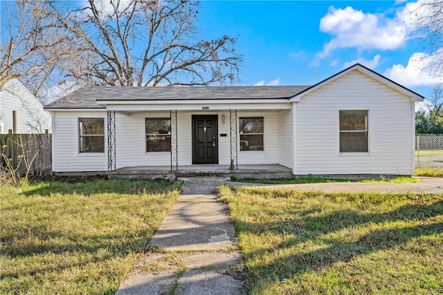 ranch-style house with covered porch and a front lawn