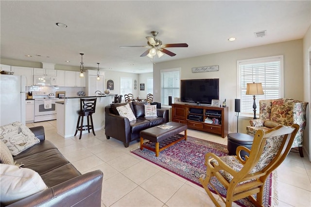 living room with ceiling fan and light tile patterned floors