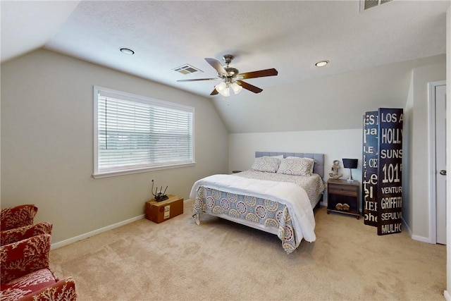 bedroom with a textured ceiling, ceiling fan, lofted ceiling, and light carpet