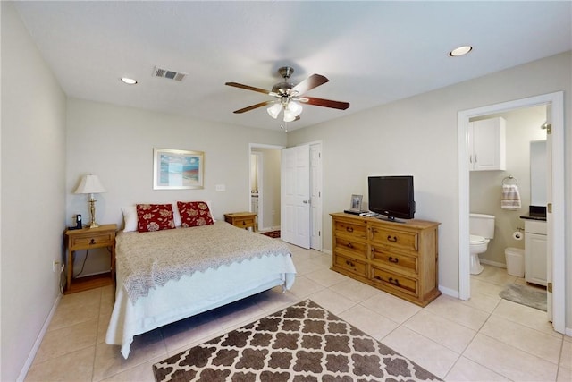 tiled bedroom with ensuite bathroom and ceiling fan