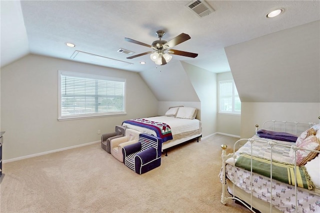 carpeted bedroom featuring ceiling fan, lofted ceiling, and a textured ceiling