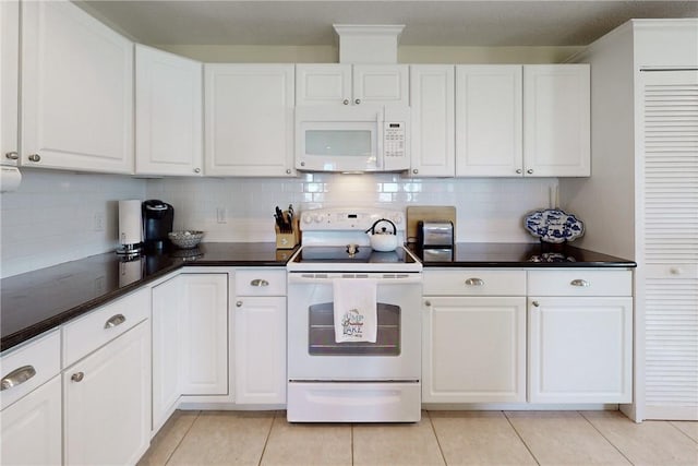 kitchen featuring light tile patterned floors, white appliances, tasteful backsplash, and white cabinetry