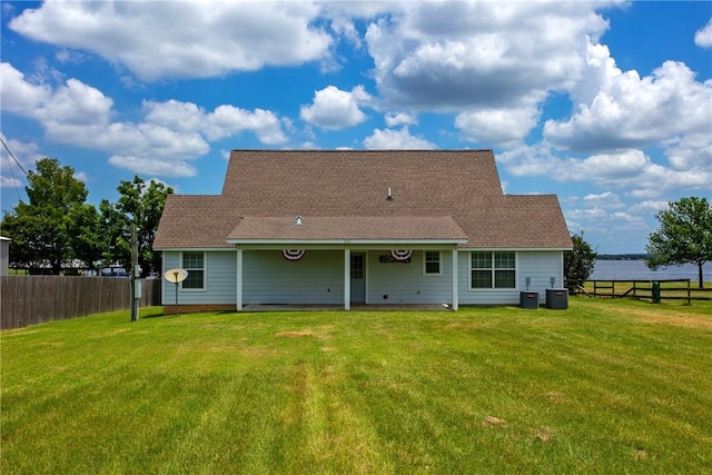 back of property featuring a yard and central AC unit