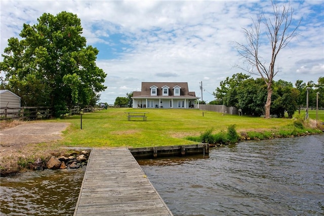 dock area featuring a yard and a water view