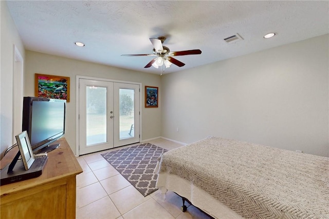 tiled bedroom with french doors, a textured ceiling, access to outside, and ceiling fan