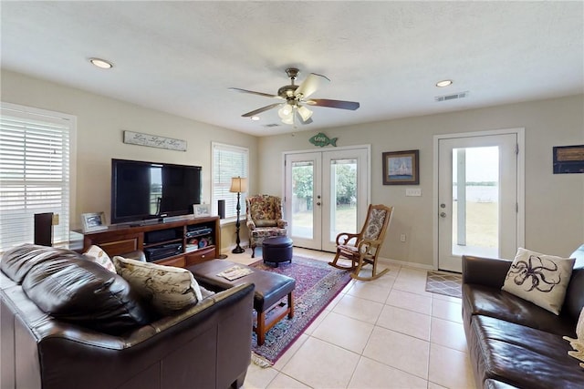 tiled living room featuring french doors and ceiling fan