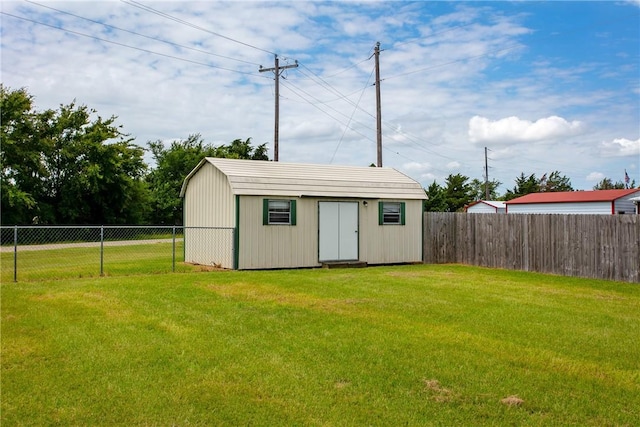 view of outbuilding with a yard