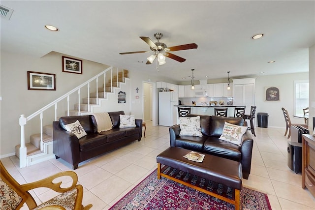 living room featuring ceiling fan and light tile patterned flooring