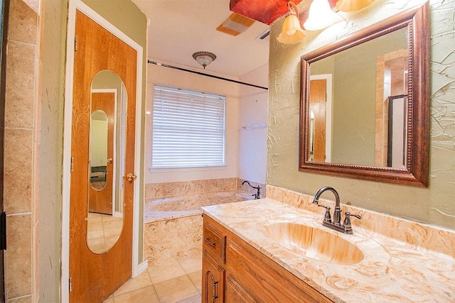 bathroom featuring tile patterned floors, vanity, and a bathing tub