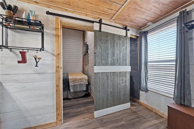 bedroom featuring multiple windows, hardwood / wood-style floors, wooden ceiling, and wood walls