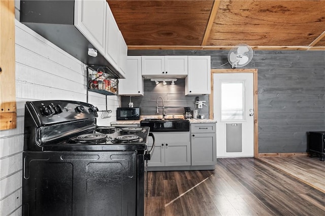 kitchen with sink, black appliances, dark hardwood / wood-style floors, and white cabinets