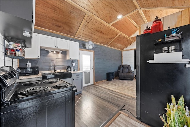 kitchen featuring sink, white cabinetry, electric range oven, wooden ceiling, and fridge