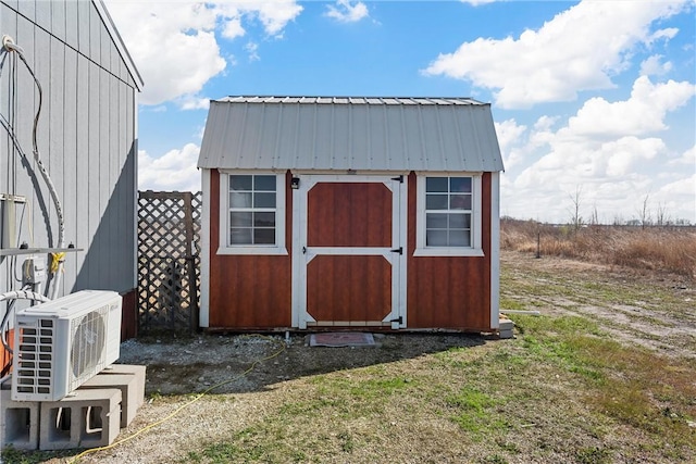 view of outdoor structure featuring ac unit and a lawn