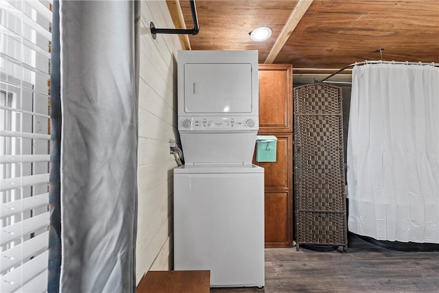 laundry room with wood ceiling, dark hardwood / wood-style floors, and stacked washer and clothes dryer