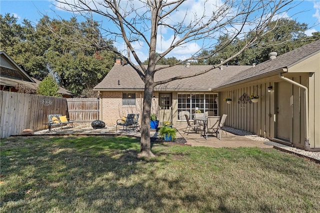 back of property featuring a patio area and a yard