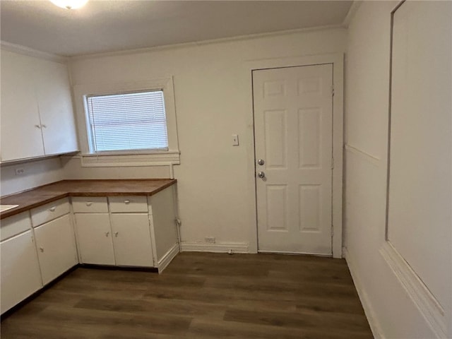 kitchen featuring crown molding, white cabinetry, and dark wood-type flooring