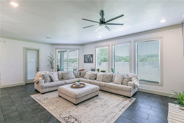 living room featuring a textured ceiling, ceiling fan, and ornamental molding