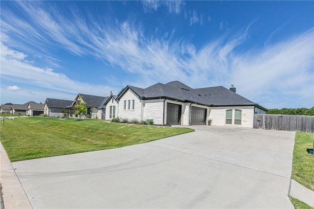 view of front of home with a garage and a front lawn