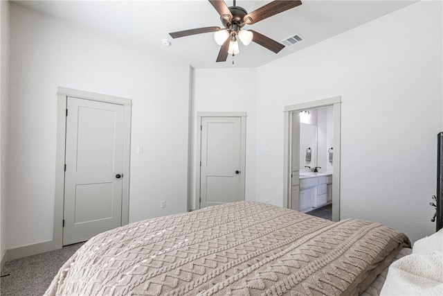 carpeted bedroom featuring ensuite bathroom and ceiling fan