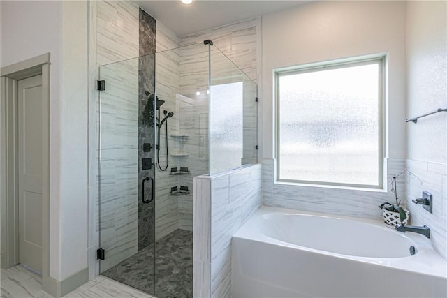 bathroom featuring independent shower and bath