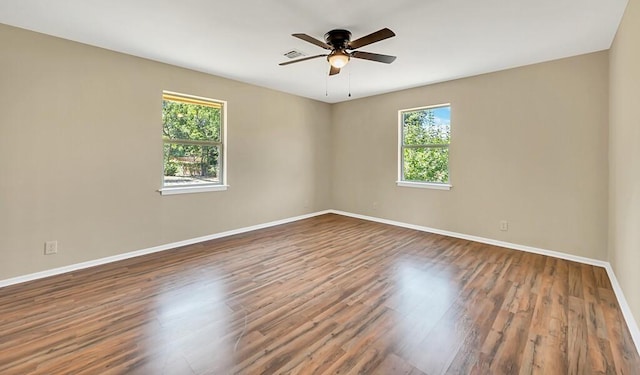 empty room featuring ceiling fan and hardwood / wood-style floors