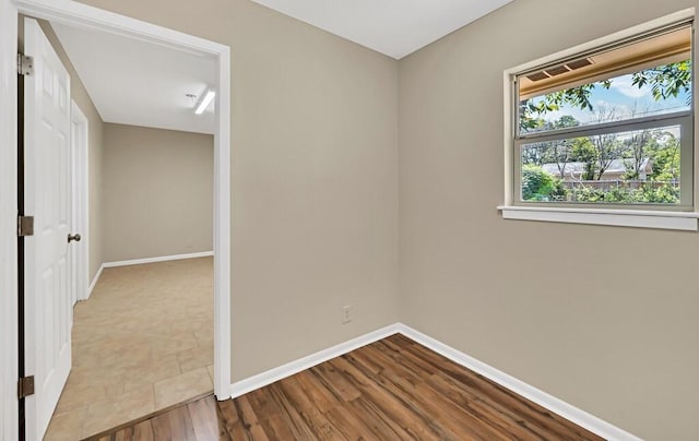 empty room with hardwood / wood-style flooring