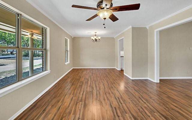 spare room featuring ceiling fan with notable chandelier, dark hardwood / wood-style floors, and crown molding