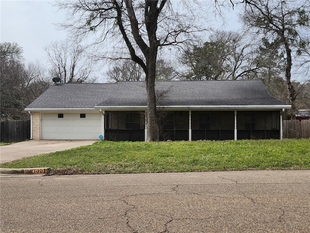 view of front facade featuring a garage, brick siding, fence, a sunroom, and driveway