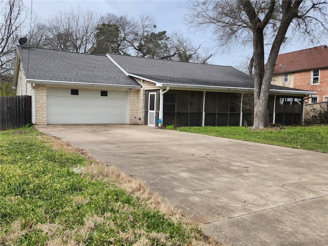 view of front of property with a garage, stone siding, a sunroom, and concrete driveway