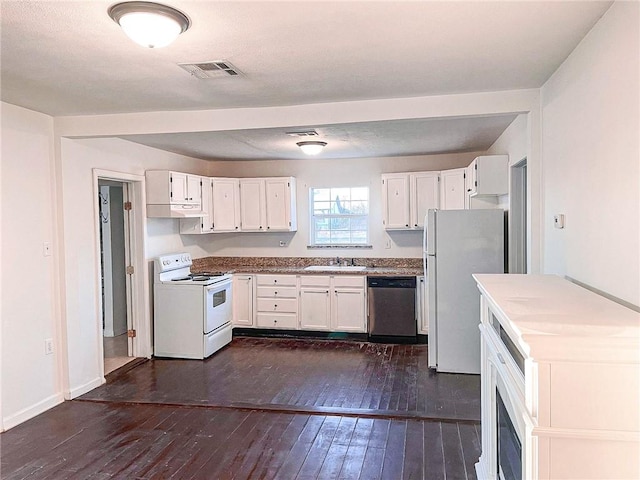 kitchen featuring dark hardwood / wood-style flooring, sink, white cabinets, and white appliances