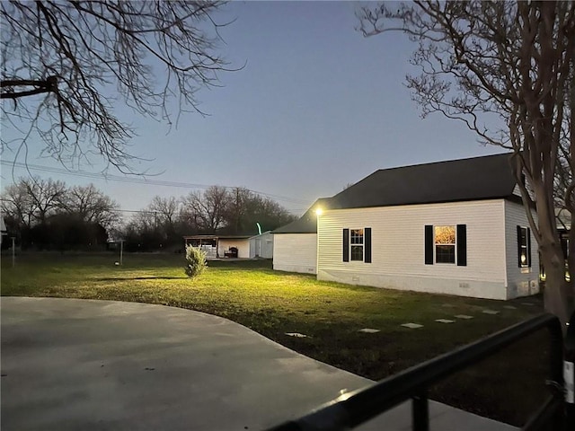 view of side of property with a lawn