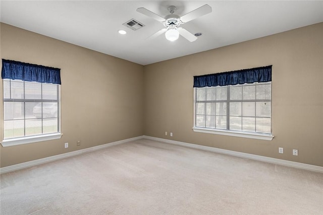 carpeted empty room featuring ceiling fan