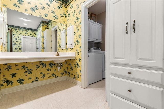 bathroom featuring washing machine and clothes dryer