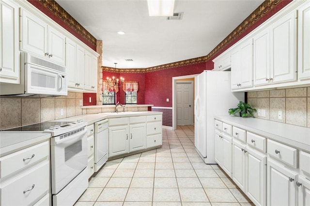 kitchen featuring hanging light fixtures, an inviting chandelier, white cabinets, white appliances, and light tile patterned flooring